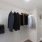 a closet with clothes and a bag