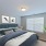 a bedroom with a bed and a plant