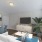 a living room with a tv and couches