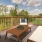 a deck with chairs and a table