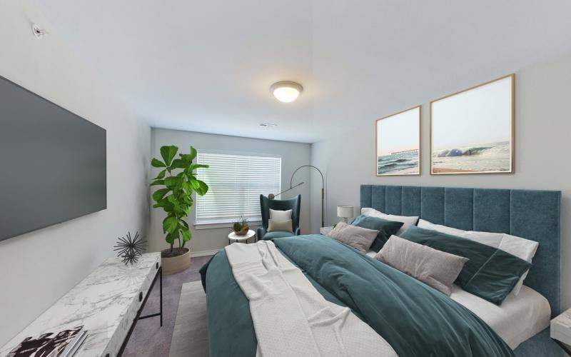 a room with a bed and a plant