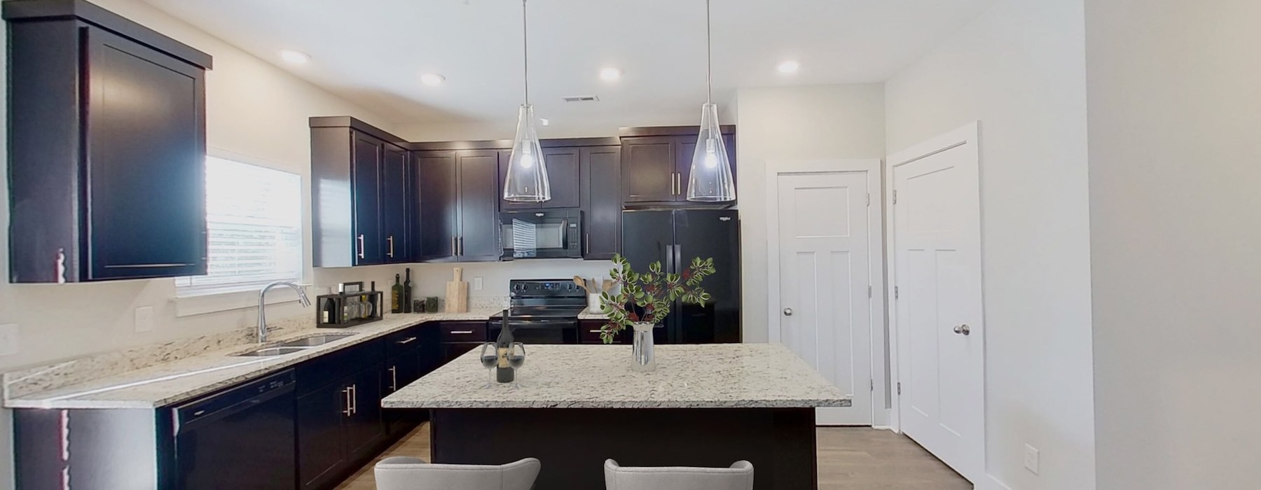 a kitchen with a marble island
