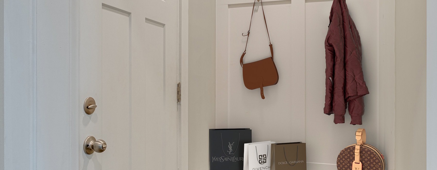 an entry area with hooks and a shoe holder