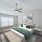 a bedroom with a bed and a fan